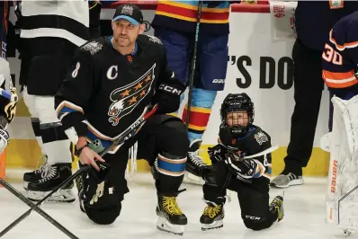  ?? (AP Photo/Marta Lavandier) ?? Washington Capitals’ Alex Ovechkin (8) and his son waits for the events to start Friday during the NHL All Star Skills Showcase in Sunrise, Fla.