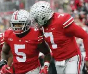  ?? JAY LAPRETE — THE ASSOCIATED PRESS ?? Ohio State running back Mike Weber, left, celebrates his touchdown against Michigan with teammate quarterbac­k Dwayne Haskins during the second half of an NCAA college football game Saturday in Columbus, Ohio. Ohio State beat Michigan 62-39.