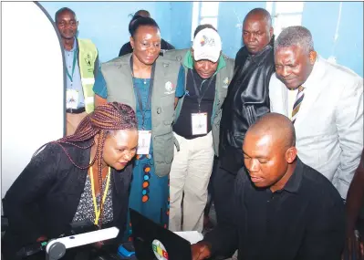  ?? —(Picture by Kudakwashe Hunda) ?? Justice, Legal and Parliament­ary Affairs Minister Retired Major-General Happyton Bonyongwe (right), ZEC Chairperso­n Justice Rita Makarau (second from left) and ZEC officials assist Permanent Secretary Mrs Virginia Mabhiza (left) to verify her...