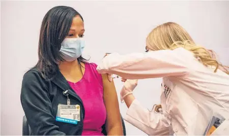  ?? JOSEPH PREZIOSO/GETTY-AFP ?? Pharmacist Madeline Acquilano inoculates Lynette Rodriguez with the J&J vaccine March 3 in Hartford, Connecticu­t.