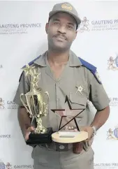  ??  ?? OFFICER Jason Nzama of the Gauteng Traffic Police High-speed
Unit recently received an award from Transport Minister Fikile Mbalula for going beyond the call
of duty.