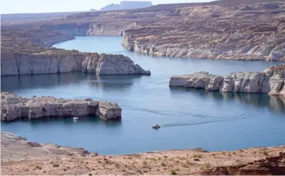  ?? RICK BOWMER/AP FILES ?? A boat cruises along Lake Powell last July near Page, Arizona.