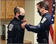  ?? COURTESY OF PENNRIDGE REGIONAL POLICE ?? Pennridge Regional Police Officer Russell Closs III has his badge pinned on by his father, Perkasie Borough Police Detective Sgt. Russell Closs II.