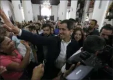  ?? AP PHOTO/FERNANDO LLANO ?? Opposition National Assembly leader Juan Guaido, who declared himself interim president, greets supporters as he arrives to attend Mass at a church in Caracas, Venezuela, Sunday, Jan. 27, 2019.