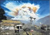  ?? AP ?? Smoke rises from Apple Fire in Cherry Valley, California.