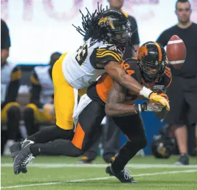  ?? CP FILE PHOTO ?? Don Unamba of the Hamilton Tiger-Cats knocks down a pass intended for B.C. Lions receiver Emmanuel Arceneaux during a Sept. 22 game at B.C. Place.