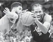  ?? CHARLES KRUPA AP ?? Clippers forward Kawhi Leonard (2) hangs onto ball against Celtics forward Jayson Tatum on Thursday.