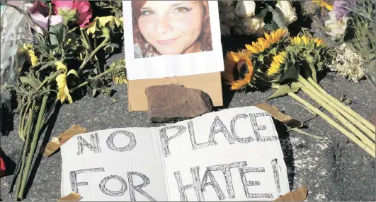  ?? Picture: AP ?? CASUALTY: A makeshift memorial of flowers and a photo of the victim of the car attack is on display at the site in Charlottes­ville, Virginia, on Sunday.