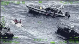  ?? SEVENTH U.S. COAST GUARD DISTRICT VIA AP ?? People stand on a capsized boat, left, as some of its passengers are pulled up on to a rescue boat, top, in the open waters northwest of Puerto Rico on Thursday.