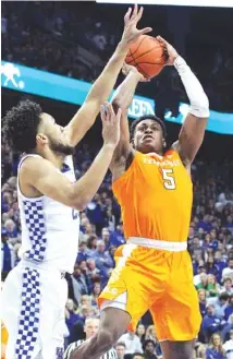  ?? AP PHOTO/JAMES CRISP ?? Tennessee’s Admiral Schofield shoots while pressured by Kentucky’s E.J. Montgomery during the second half of Saturday’s game against Kentucky in Lexington, Ky. Kentucky won 86-69.