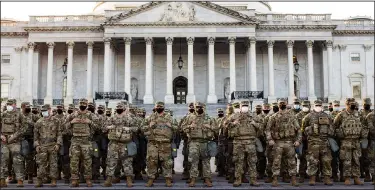  ?? (The New York Times/Jason Andrew) ?? National Guard troops, part of a large security force, muster Thursday outside the U.S. Capitol.