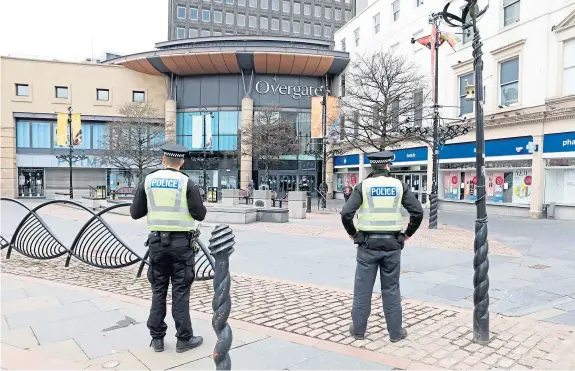  ?? Picture: Gareth Jennings. ?? Police officers on patrol in Dundee city centre as the new powers in the Coronaviru­s Act come into force.