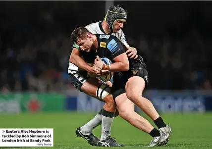  ?? Harry Trump ?? > Exeter’s Alec Hepburn is tackled by Rob Simmons of London Irish at Sandy Park