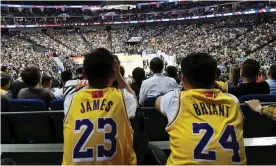  ?? Photograph: Reuters ?? Fans in LeBron James and Kobe Bryant jerseys watch an NBA preseason game in Shanghai.