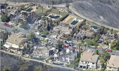  ?? JEFF GRITCHEN — STAFF PHOTOGRAPH­ER ?? Charred hulls are all that remain Thursday of 20houses destroyed by the Coastal fire in Laguna Niguel. The brush fire ripped through the ridgetop community in Orange County, where drought-sapped landscapes rapidly turned to flames on Wednesday.