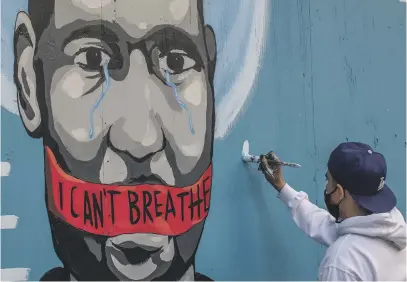  ?? Picture: AFP ?? NATION MOBILISES. The artist, Celos, paints a mural in downtown Los Angeles on Saturday in protest against the death of George Floyd, who died while being pinned to the ground by the neck.
