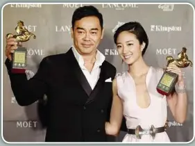  ??  ?? Top winners: Gao (left) checking his statuette while Lau and Gwei pose with theirs after winning the awards. — AP