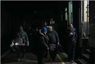  ?? BERNAT ARMANGUE — THE ASSOCIATED PRESS ?? Ukrainians board the Kherson-Kyiv train Saturday at the Kherson railway station to get out of the city that is being bombed daily by Russians from across the Dnipro River.