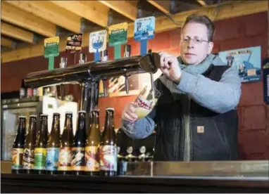  ?? THE ASSOCIATED PRESS ?? Yvan De Baerts, owner of “Brasserie de la Senne”, pours a beer at his brewery in Brussels on Wednesday, Nov. 30, 2016. Belgium is known throughout the world for its wide array of tastes, from extreme sour to bitter, produced in just about every city...