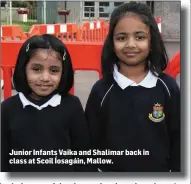  ??  ?? Junior Infants Vaika and Shalimar back in class at Scoil Íosagáin, Mallow.