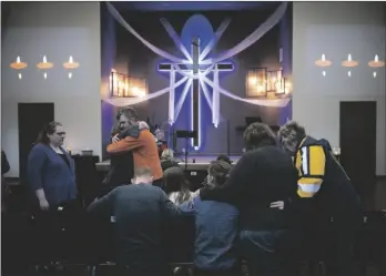  ?? JEFF WHEELER/STAR TRIBUNE VIA AP ?? Relatives of Iliana “Lily” Peters comfort each other as they pray together at a vigil for the 10 year-old girl at Valley Vineyard Church in Chippewa Falls, Wis., on Monday evening.