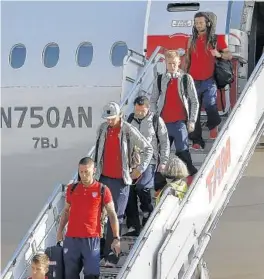  ?? MIGUEL SCHINCARIO­L/GETTY IMAGES PHOTO ?? The United States national soccer team gets off the plane upon arrival at Guarulhos Internatio­nal Airport in Sao Paulo, Brazil on Monday.
