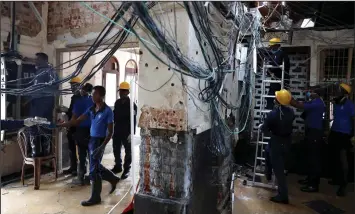  ??  ?? Personnel clean up the St. Anthony’s Shrine, days after a string of suicide bomb attacks on churches and luxury hotels across the island on Easter Sunday, in Colombo. — Reuters photo