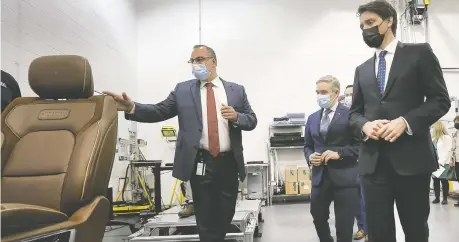  ?? DAN JANISSE ?? Tony Mancina, head of engineerin­g for Stellantis Canada, from left, gives a tour of a Windsor facility to Economic Developmen­t Minister Francois-philippe Champagne and Prime Minister Justin Trudeau during an announceme­nt of $3.6-investment in Stellantis's Windsor facilities on Monday.