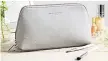  ??  ?? Pebblegrai­n grey leather make-up bag, £39, The White Company