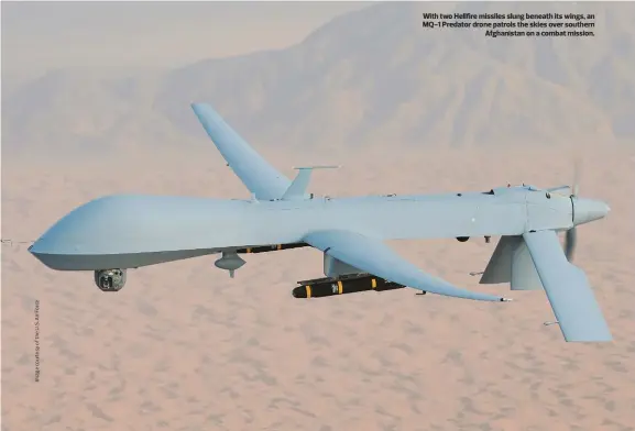  ??  ?? With two Hellfire missiles slung beneath its wings, an MQ-1 Predator drone patrols the skies over southern Afghanista­n on a combat mission.