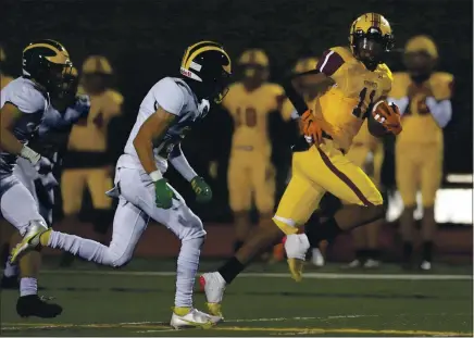  ?? KARL MONDON — STAFF PHOTOGRAPH­ER ?? Las Lomas’ Jabre Bevineau (11) catches a third-quarter pass ahead of San Ramon Valley’s Eddie Williams during the spring season in Walnut Creek.