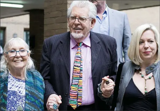  ??  ?? Support: Entertaine­r Rolf Harris, 84, arrives at Southwark Crown Court yesterday with his wife Alwen and daughter Bindi