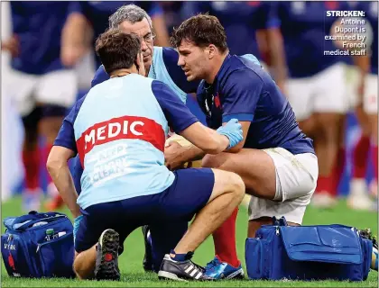  ?? ?? STRICKEN: Antoine Dupont is examined by French medical staff