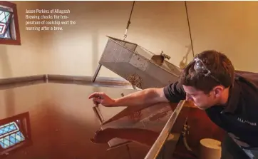  ??  ?? Jason Perkins of Allagash Brewing checks the temperatur­e of coolship wort morning after a brew. the