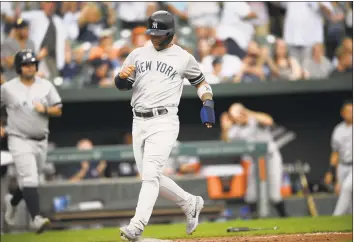  ?? Nick Wass / Associated Press ?? The New York Yankees’ Gleyber Torres comes in to score from third on a bases-loaded walk during the ninth inning against the Baltimore Orioles on Thursday.