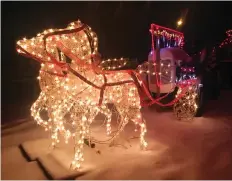  ?? JOHN GRAINGER ?? One of the staples of the Christmas lights season is this house on Egbert Avenue in Sutherland. Every year, there are vintage tractors festooned with lights among an array of other displays.