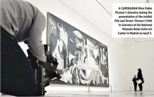  ??  ?? A CAMERAMAN films Pablo Picasso’s Guernica during the presentati­on of the exhibit Pity and Terror: Picasso’s Path to Guernica at the National Museum Reina Sofia Art Center in Madrid on April 3.