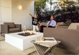  ??  ?? DAVID GOLUBCHIK and son Alek enjoy the fire pit in the Santa Monica house’s backyard, a substantia­l space that had drawn David and his wife to the property.