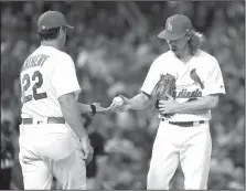  ?? AP/JEFF ROBERSON ?? Cardinals starting pitcher Mike Leake (right) hands the ball to manager Mike Matheny as Leake is removed from the game against the Marlins on Wednesday in St. Louis.