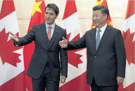  ?? CANADIAN PRESS ?? Chinese President Xi Jinping extends his hand as Canadian Prime Minister Justin Trudeau introduces the Canadian delegation before a meeting at the Diaoyutai State Guesthouse in Beijing.