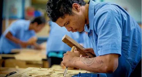 ?? MURRAY WILSON / FAIRFAX NZ ?? Manawatu College pupil Mani Miller, working on a pou a carved panel with a message, used inside marae.