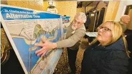  ?? ?? James Enck of the River Corridor Foundation shows a visitor options concerning the Fox River in St. Charles before the presentati­on “Dam Alternativ­es and Understand­ing Options” at the Arcada Theatre in St. Charles on Wednesday.