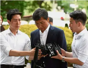  ?? — AFP ?? Day in court: Ahn (centre) arriving at a court for his sex abuse trial in Seoul.