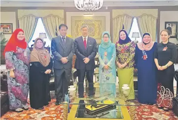  ??  ?? Ahmad Zahid (fourth left) and Fatimah (fifth left) with members of her entourage at the Deputy Prime Minister’s Office in Kuala Lumpur yesterday.