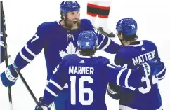  ?? DAN HAMILTON / USA TODAY SPORTS ?? Auston Matthews celebrates scoring against the Ottawa Senators with forwards Mitchell Marner and Joe Thornton on Thursday.