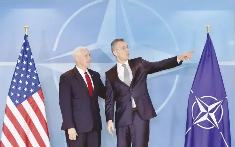  ?? — Reuters ?? Nato Secretary-General Jens Stoltenber­g welcomes US Vice President Mike Pence at the Nato headquarte­rs in Brussels, Belgium, on Monday.