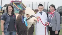  ??  ?? Show Queen Hannah McLarnin at Ballymena on Saturday (main picture); Jason Whitcroft from Armagh (above) was the reserve champion young handler in the beef section at the show. He is congratula­ted by Treenie Bowser from sponsor Parklands Veterinary...