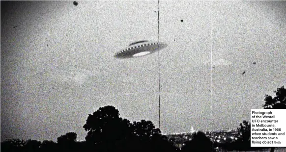  ?? Getty ?? Photograph of the Westall UFO encounter in Melbourne, Australia, in 1966 when students and teachers saw a flying object