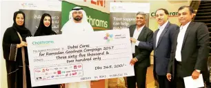  ?? — Supplied photo ?? Officals of Dubai Cares and Choithrams during a ceremeony at Al Ghazal supermarke­t to hand over the amount collected by the supermarke­t chain as part of the Year of Giving initiative.