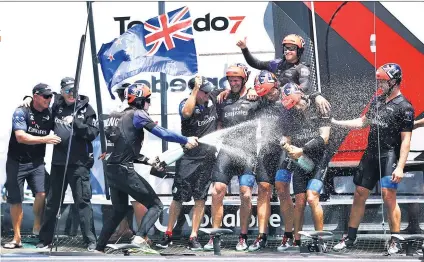  ??  ?? Party time: Emirates Team New Zealand celebrate after sealing their victory